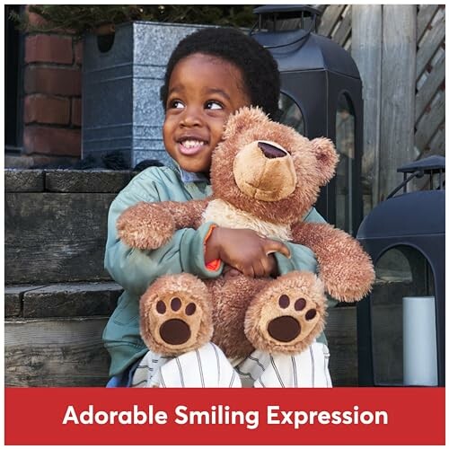 Child smiling and hugging a teddy bear.