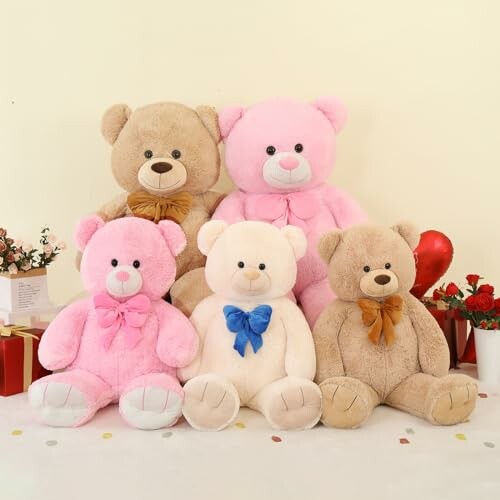 A group of five colorful teddy bears with bows