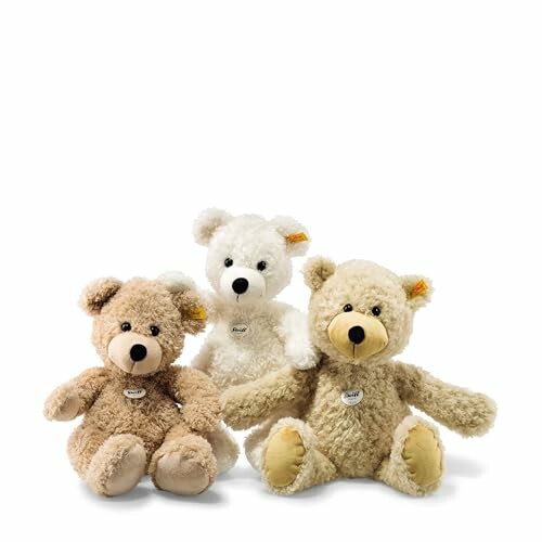 Three fluffy teddy bears in different colors.